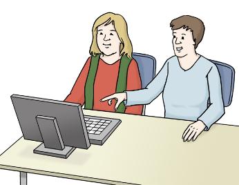 Zwei Personen sitzen an einem PC